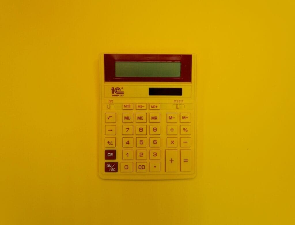 Calculator with a yellow background indicating a lot size calculator