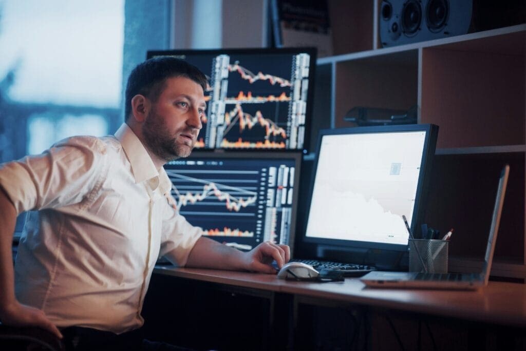 Trader at his desk looking panicked because of poor risk management
