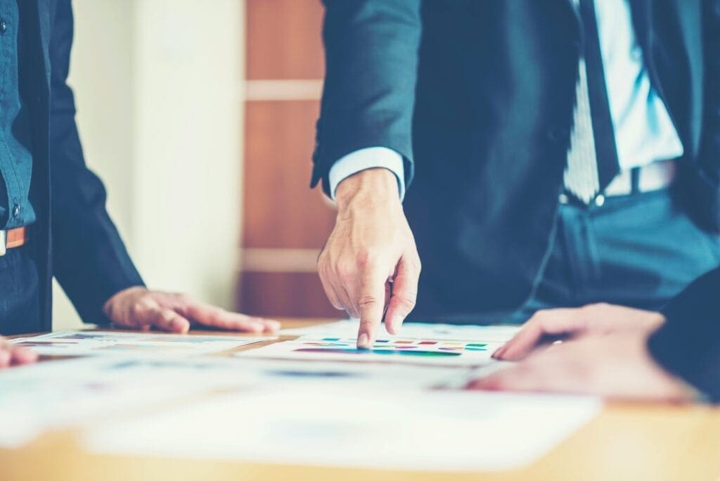Executive pointing at figures showing he wants to mange risk