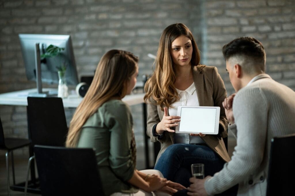 Woman showing collegues what do do in a practical example
